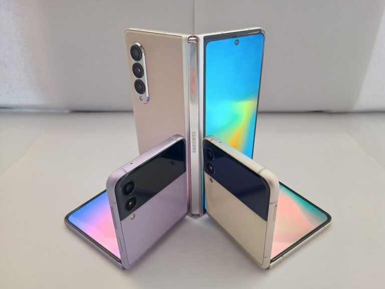 A foldable smartphone half-open on a desk